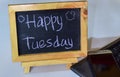 Phrase happy tuesday written on a chalkboard on it and smartphone, laptop Royalty Free Stock Photo