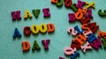 The phrase `Have a good day` wooden colored letters on the table mint color.