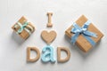 Phrase I LOVE DAD and gift boxes on light background. Royalty Free Stock Photo