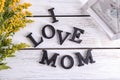 Phrase I love mom made of letters on wooden background. Greeting for Mother's day Royalty Free Stock Photo