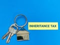 Phrase inheritance tax written on sticky note with house keys. Royalty Free Stock Photo