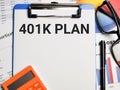 Phrase 401K PLAN written on paper clipboard