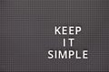 Phrase Keep It Simple spelled out with white letters on gray pegboard Royalty Free Stock Photo