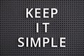 Phrase Keep It Simple spelled out with white letters on a gray pegboard. Close-up Royalty Free Stock Photo