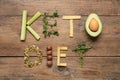 Phrase Keto Diet made with different products on wooden table, flat lay