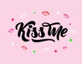 Phrase Kiss me hand lettering on pink background with colorful lips. Vector