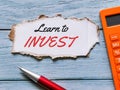 Phrase learn to invest written on strip cupboard