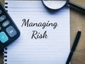 Phrase MANAGING RISK written on a piece of paper