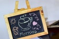 Phrase morning love written on a chalkboard on it and smartphone, laptop Royalty Free Stock Photo