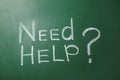 Phrase `Need help?` written on chalkboard