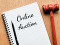 Phrase ONLINE AUCTION written on note book