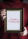 Phrase Season`s Greetings in a frame Royalty Free Stock Photo