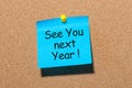 Phrase See you next year pinned at cork board Royalty Free Stock Photo