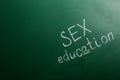 Phrase `SEX EDUCATION` written on green chalkboard