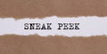 The phrase Sneak Peek appearing behind torn brown paper Royalty Free Stock Photo