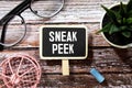 The phrase Sneak Peek appearing behind torn paper. Royalty Free Stock Photo