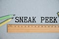 The phrase Sneak Peek appearing behind torn paper. Royalty Free Stock Photo