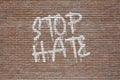Phrase Stop Hate spray painted in white on a brick wall Royalty Free Stock Photo