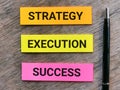 Phrase STRATEGY EXECUTION SUCCESS written on sticky note with a pen. Royalty Free Stock Photo