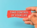 Phrase TAKE CONTROL OF YOUR LIFE on red strip paper