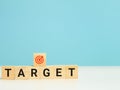 Phrase TARGET on wooden cubes isolated on blue background.