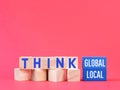 Phrase think global or local on wooden blocks.