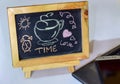 Phrase Time is Love written on a chalkboard on it and smartphone, laptop. Royalty Free Stock Photo
