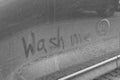 Phrase Wash Me and sad emoticon drawn on dirty car, closeup Royalty Free Stock Photo