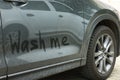 Phrase Wash Me written on dirty car, closeup Royalty Free Stock Photo