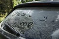 Phrase Wash me written on dirty car window outdoors, closeup Royalty Free Stock Photo