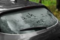 Phrase Wash me written on dirty car window outdoors, closeup Royalty Free Stock Photo