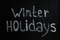 Phrase Winter Holidays written on black chalkboard Royalty Free Stock Photo