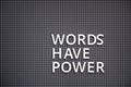 Phrase Words Have Power spelled out with white letters on pegboard