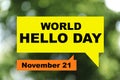 Phrase World Hello Day November 21 on blurred green background. Bokeh effect