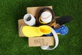 Phrase Yard Sale written on box with different stuff on green grass, top view Royalty Free Stock Photo