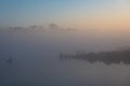 Sunrise and silhouette of pine tree at water pond on the mountain top of Phu Kradueng National Park