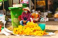 Phu Quoc Island, Vietnam, February 26 2018: Vietnamese Flower Seller selling Yellow flowers on traditional street market