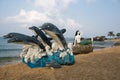 Sculpture of the Mermaid and dolphins on the beach