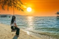 Silhouette of traveler Asian woman watching the sunset