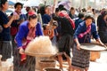 Phu Thai minority woman pounding and winnowing rice.