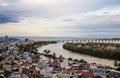 Aerial view of of urban cityscape with Hung Vuong bridge across the Ba river at dusk