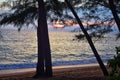 Phuket beach sunset, colorful cloudy twilight sky reflecting on the sand gazing at the Indian Ocean, Thailand