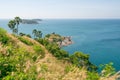 Phuket island Laem promthep cape with coconut palm trees and grass in the foreground beautiful scenery andaman sea in summer