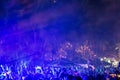 A crowd of young people dancing at night at the New Year`s Eve celebration on the beach in the tropics Royalty Free Stock Photo