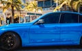 PHUKET, THAILAND- DECEMBER 25, 2023: Beautiful bright blue BMW M3 series in the parking lot. Royalty Free Stock Photo