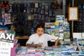 A beautiful young Thai woman sells sightseeing tours