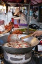 Phuket, Thailand, January 8, 2020: Street food in Thailand. deep-fried chicken using a large frying pan with boiling oil. Food Royalty Free Stock Photo