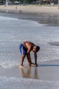 Local Asian children on the beach. Three boys playing in the waves. Royalty Free Stock Photo