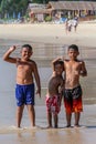 Local Asian children on the beach. Three boys playing in the waves. Royalty Free Stock Photo