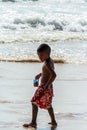 Local Asian children on the beach. Three boys playing in the waves. Royalty Free Stock Photo